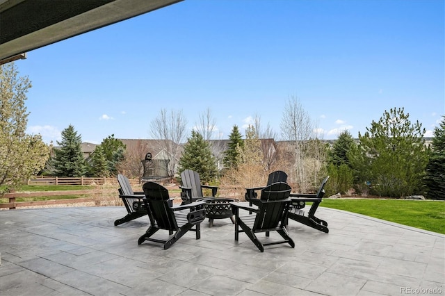 view of patio featuring a fire pit and fence