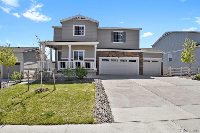 5166 Trails Edge Ln, Castle Rock, CO 80104 - view of front facade with a porch, driveway, stone siding, and a garage