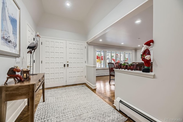 foyer with baseboard heating and hardwood / wood-style flooring