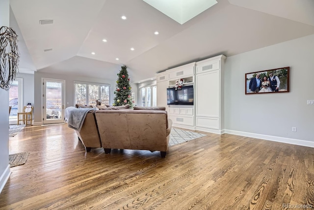 living room featuring hardwood / wood-style floors and lofted ceiling