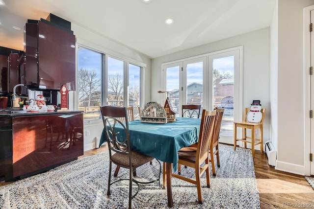 dining area with light hardwood / wood-style flooring and a baseboard radiator