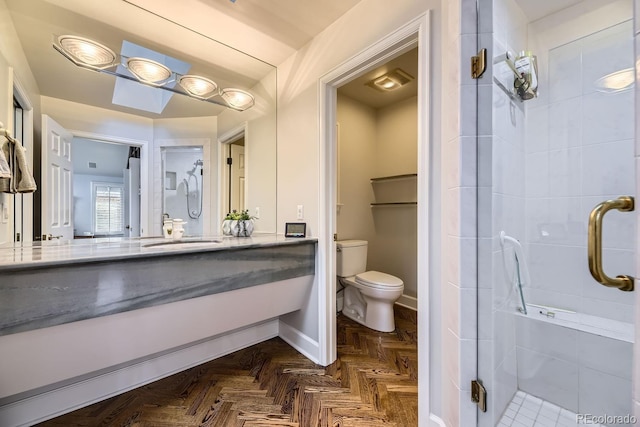 bathroom with walk in shower, vanity, parquet floors, and toilet