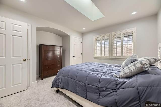 bedroom featuring light carpet and a skylight