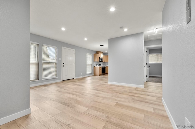 unfurnished living room featuring light hardwood / wood-style floors