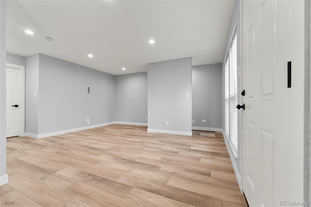 unfurnished room featuring a healthy amount of sunlight and light wood-type flooring