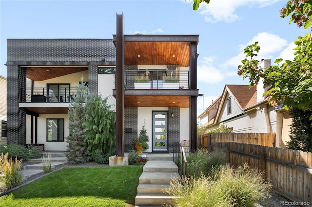 3617 Shoshone St, Denver, CO 80211 - view of front facade with a balcony, stucco siding, and brick siding