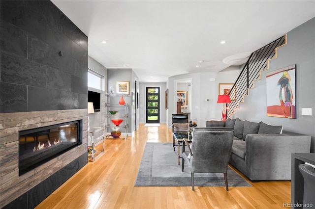 3617 Shoshone St, Denver, CO 80211 - living area with a large fireplace, wood finished floors, recessed lighting, and stairway