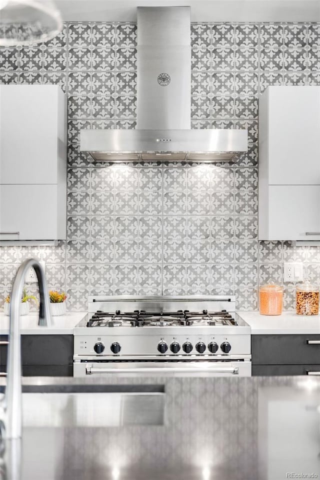 3617 Shoshone St, Denver, CO 80211 - kitchen with range hood, stainless steel range with gas cooktop, decorative backsplash, light countertops, and white cabinets