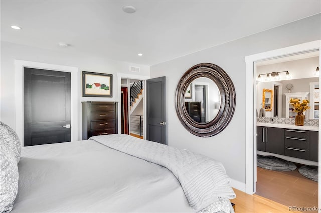 3617 Shoshone St, Denver, CO 80211 - bedroom with recessed lighting, ensuite bathroom, and light wood-style flooring