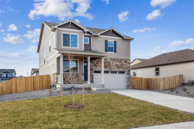 craftsman-style home featuring a porch, a front yard, and a garage