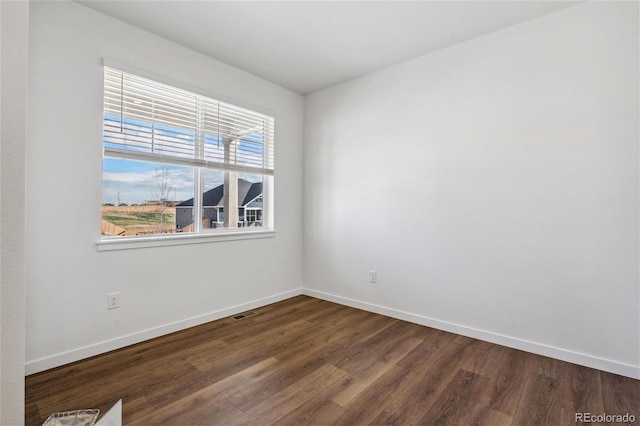 empty room featuring dark wood-type flooring