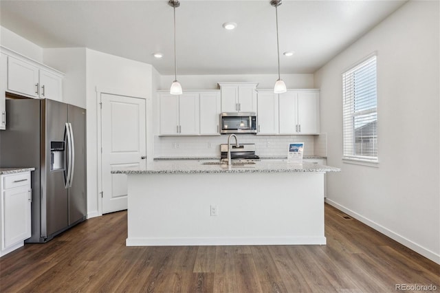 kitchen featuring decorative light fixtures, dark hardwood / wood-style flooring, and stainless steel appliances