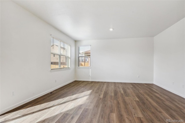 unfurnished room with wood-type flooring