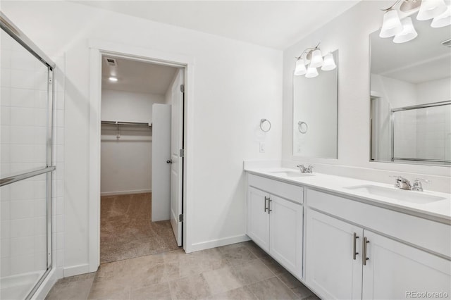 bathroom with a shower with door and vanity