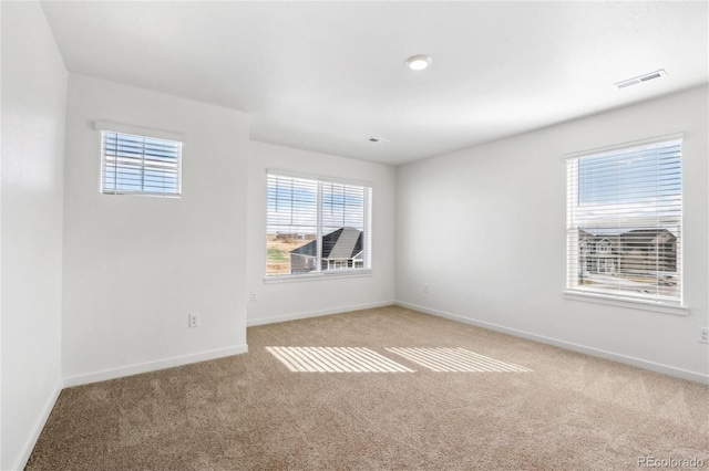 empty room featuring light carpet