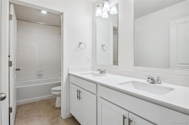 full bathroom featuring tile patterned flooring, vanity, toilet, and tiled shower / bath