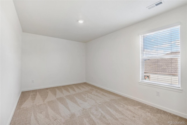 unfurnished room with plenty of natural light and light colored carpet