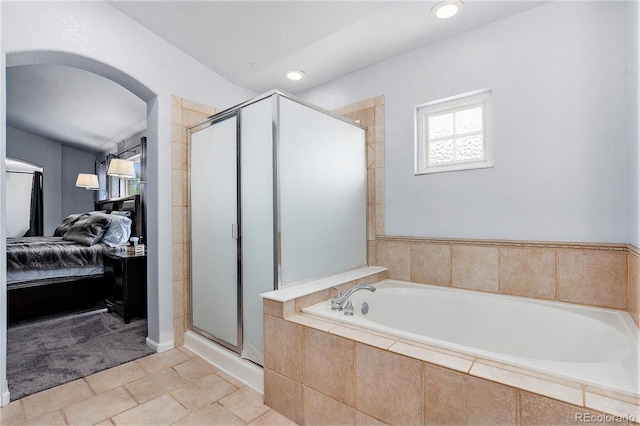 ensuite bathroom featuring a shower stall, a bath, and recessed lighting