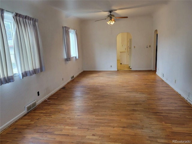 spare room featuring ceiling fan, light hardwood / wood-style flooring, and plenty of natural light