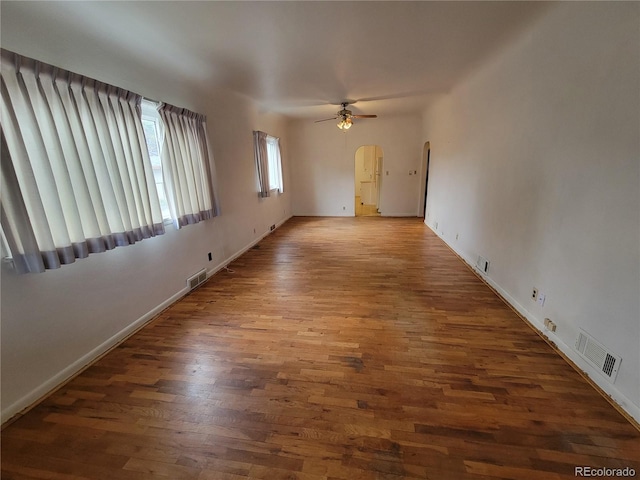 spare room featuring ceiling fan and dark hardwood / wood-style flooring