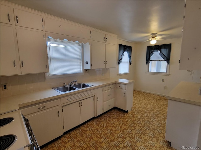 kitchen with white cabinets, tasteful backsplash, and sink