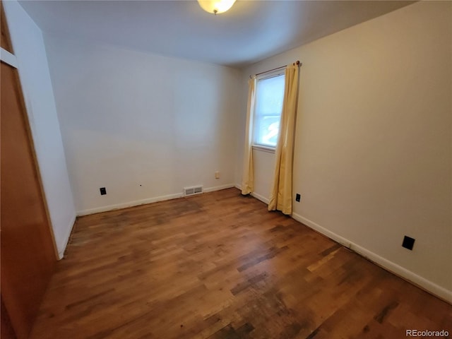 unfurnished room featuring hardwood / wood-style flooring