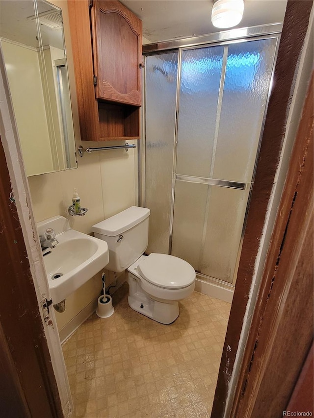 bathroom featuring toilet and walk in shower