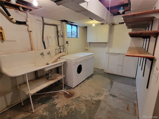 laundry area featuring washer and dryer and cabinets