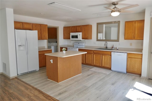 10966 Josephine St, Northglenn, CO 80233 - kitchen featuring white appliances, light wood-style flooring, light countertops, and washing machine and clothes dryer