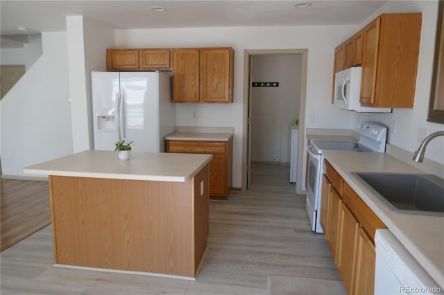 10966 Josephine St, Northglenn, CO 80233 - kitchen with white appliances, brown cabinets, light wood-style flooring, and recessed lighting