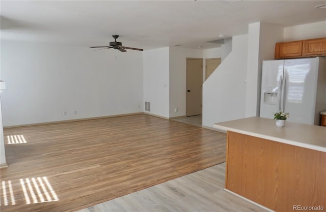10966 Josephine St, Northglenn, CO 80233 - unfurnished living room featuring a ceiling fan and light wood-style flooring
