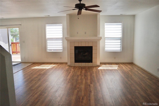 10966 Josephine St, Northglenn, CO 80233 - unfurnished living room with a ceiling fan, wood finished floors, and a tile fireplace