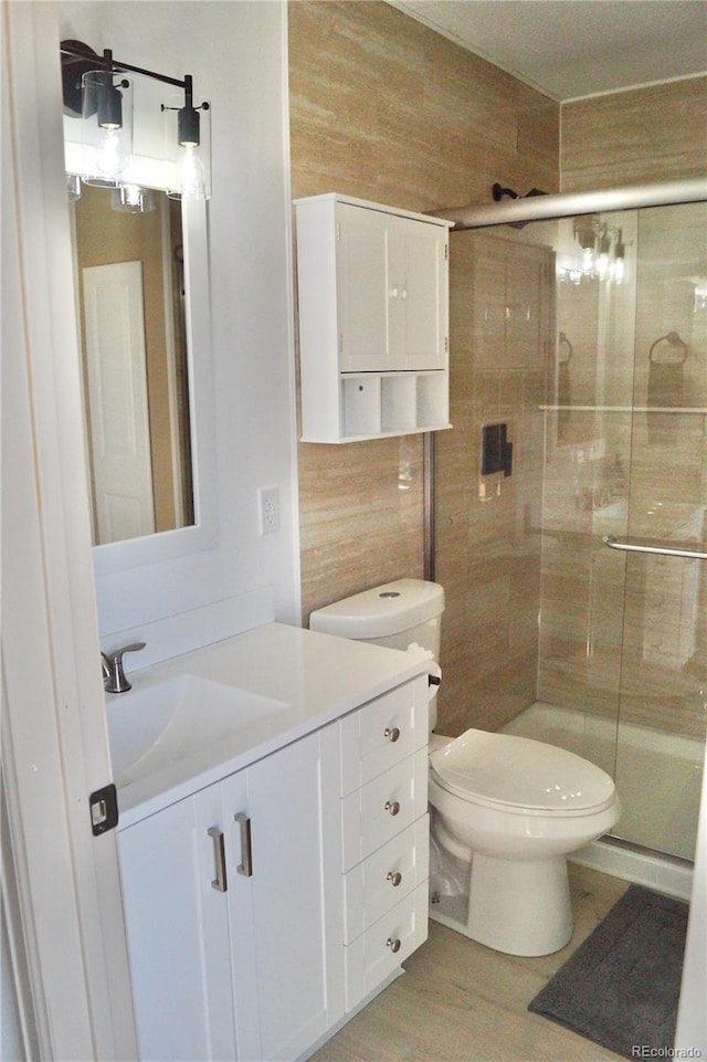 10966 Josephine St, Northglenn, CO 80233 - full bath featuring vanity, a shower stall, and wood finished floors