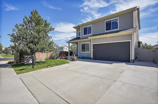 front facade featuring a garage and a front lawn