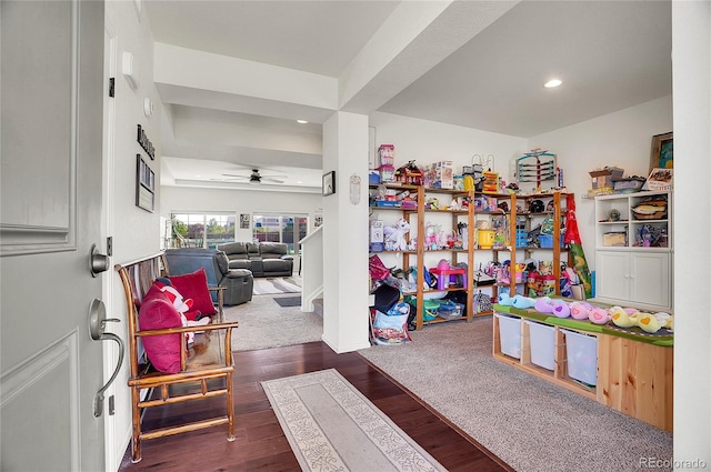 recreation room with dark wood-type flooring and ceiling fan