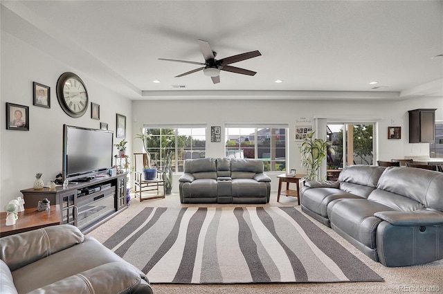 living room with light colored carpet and ceiling fan