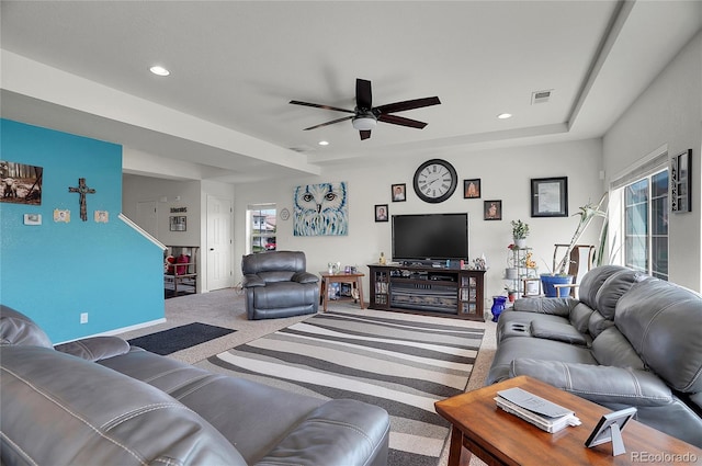 living room with ceiling fan, a wealth of natural light, and carpet