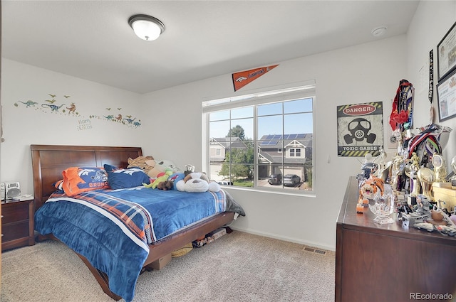 bedroom featuring light carpet