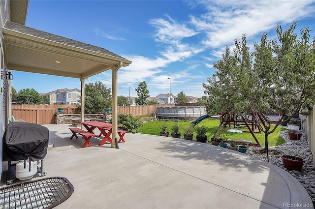 view of patio / terrace with grilling area and a playground