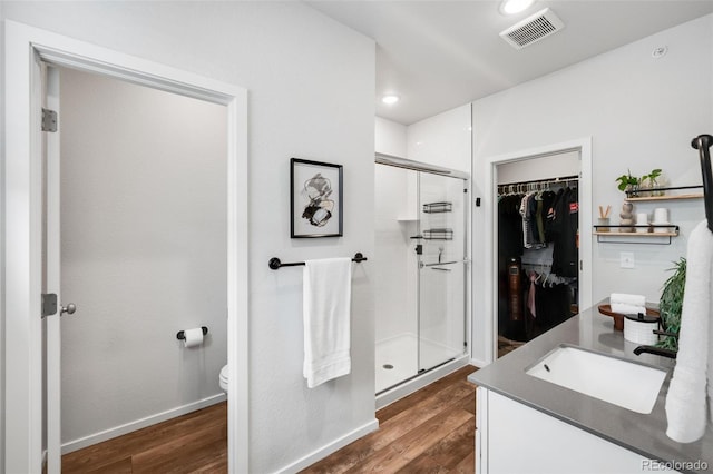 2080 Autumn Moon Dr Unit 5, Windsor, CO 80550 - bathroom featuring a stall shower, toilet, vanity, wood finished floors, and recessed lighting