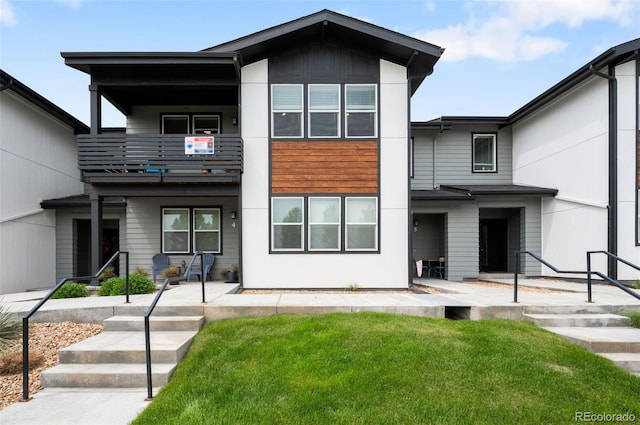 2080 Autumn Moon Dr Unit 5, Windsor, CO 80550 - view of front facade featuring a balcony, a front yard, and a patio