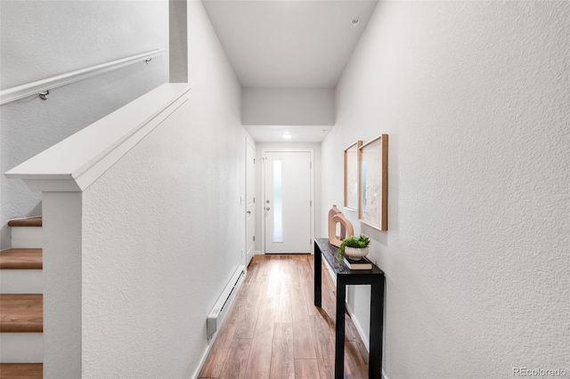 2080 Autumn Moon Dr Unit 5, Windsor, CO 80550 - entryway with baseboard heating, wood finished floors, a textured wall, and stairs