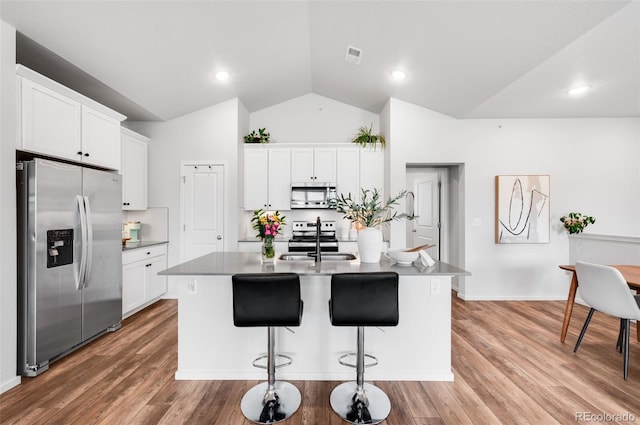 2080 Autumn Moon Dr Unit 5, Windsor, CO 80550 - kitchen with stainless steel appliances, a sink, white cabinets, a center island with sink, and high vaulted ceiling