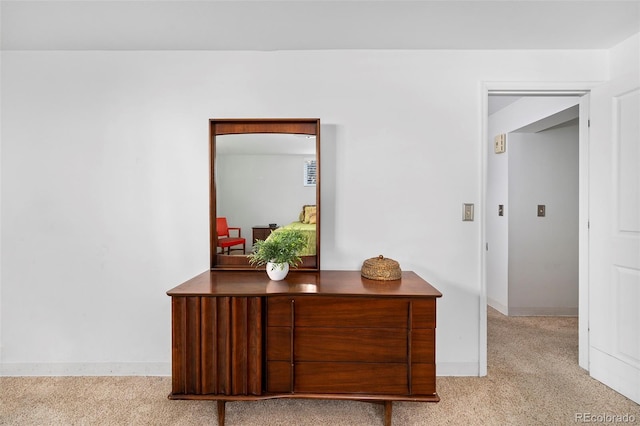 hall with light carpet and baseboards