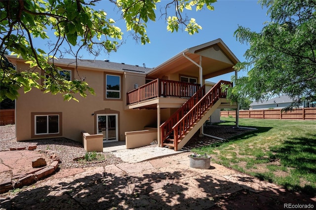 1131 N 4th St, Johnstown, CO 80534 - rear view of property with stucco siding, a wooden deck, stairway, and a patio area