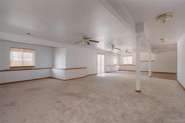 1131 N 4th St, Johnstown, CO 80534 - unfurnished living room with light colored carpet, healthy amount of natural light, and a ceiling fan
