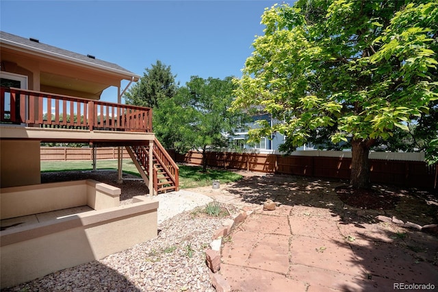 1131 N 4th St, Johnstown, CO 80534 - fenced backyard featuring stairs, a patio area, and a wooden deck