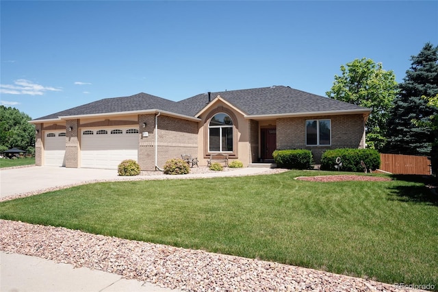 1131 N 4th St, Johnstown, CO 80534 - ranch-style home featuring brick siding, concrete driveway, an attached garage, and a shingled roof
