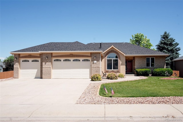 1131 N 4th St, Johnstown, CO 80534 - single story home featuring brick siding, a garage, concrete driveway, and a shingled roof
