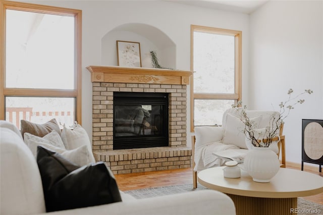 1131 N 4th St, Johnstown, CO 80534 - living area featuring wood finished floors and a brick fireplace